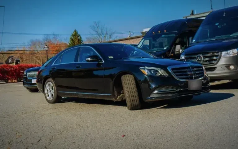 Black Mercedes-Benz S-Class sedan, three-quarter front view